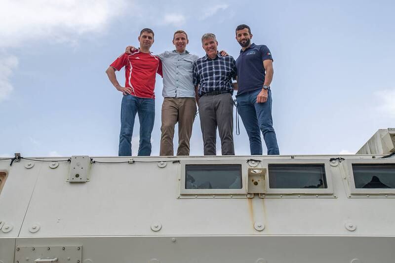 Standing on an emergency vehicle at the space centre are, from left, mission specialist Andrey Fedyaev, pilot William Hoburg, commander Stephen Bowen and Mr Al Neyadi.