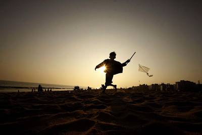 An Indian boy runs as he tries to fly a kite on the Bay of Bengal coast at Puri, Orissa state. Biswaranjan Rout / AP Photo