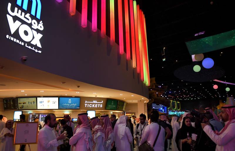 Saudis gather at a cinema theatre in Riyadh Park mall after its opening for the general public on April 30, 2018 in the Saudi capital. - Saudi Arabia lifted a decades-long ban on cinemas last year as part of a far-reaching modernisation drive, with AMC Entertainment granted the first licence to operate movie theatres. (Photo by Fayez Nureldine / AFP)