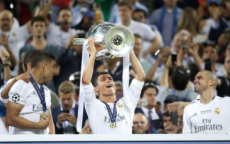 Cristiano Ronaldo holds aloft the Uefa Champions League trophy after Real Madrid beat Atletico Madrid 5-3 on penalties. Carl Recine / Action Images