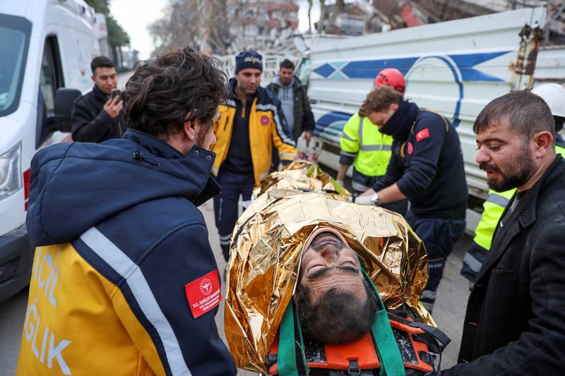 An injured man is carried to an ambulance after being rescued from the rubble in Hatay. Reuters