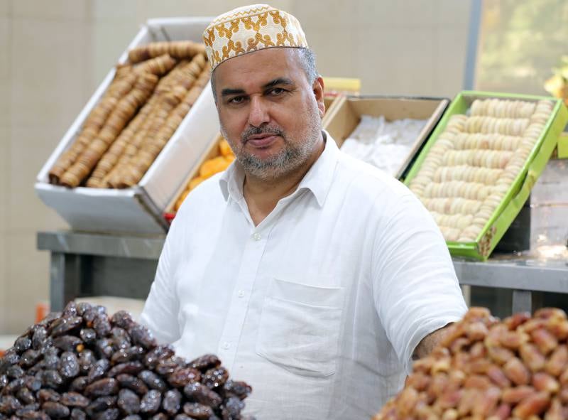 Vendor Mohammed Haneefa displays his stock. Dates at the festival are carefully prepared by hand, without any chemicals being used.
