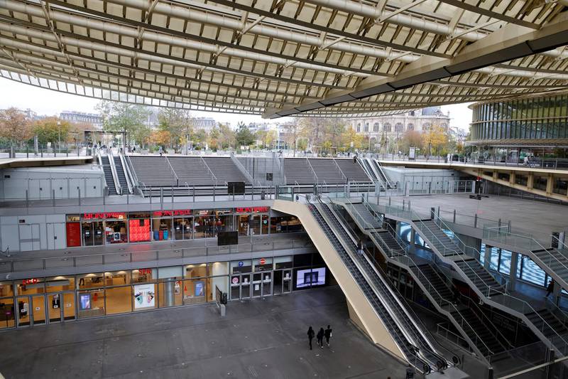 Pedestrians walk under the "Canopy" of Les Halles shopping centre, on the fourth day of a lockdown aimed at containing the spread of the novel coronavirus (Covid-19) in Paris on November 2, 2020. (Photo by Ludovic MARIN / AFP)