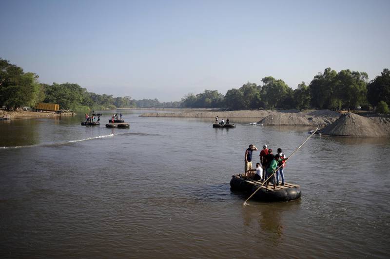 People cross Suchiate river on rafts, between Mexico and Guatemala, as seen from Ciudad Hidalgo, Mexico January 24, 2020. REUTERS/Andres Martinez Casares