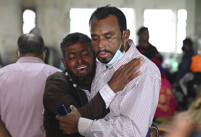 A man consoles a relative who was unable to find his 5-year-old son who was aboard the ferry which caught fire. Officials said only about 100 of the several hundred people thought to be aboard the vessel had been sent to hospitals. AP Photo