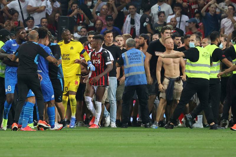 Fans try to invade the pitch during the match between Nice andMarseille. AFP