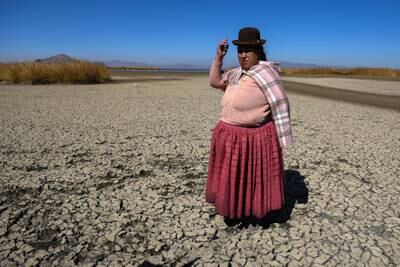 Isabel Apaza in an arid Lake Titicaca during the drought in Huarina, Bolivia. Reuters