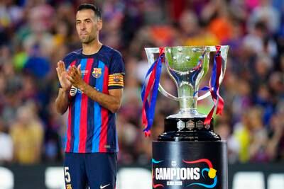 Barcelona's Sergio Busquets celebrates with the La Liga trophy at a farewell ceremony after their last home match. EPA 