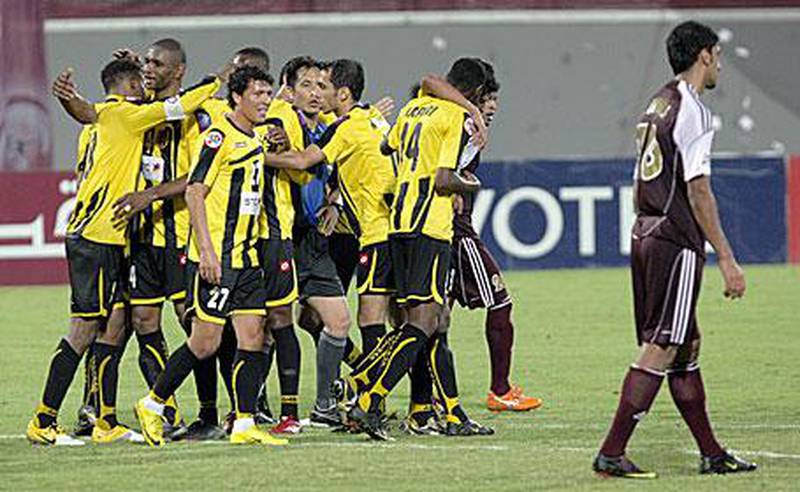Al Ittihad players celebrate their 2-0 Asian Champions League victory over Al Wahda last night. The loss was Wahda's third in three matches in Group B.