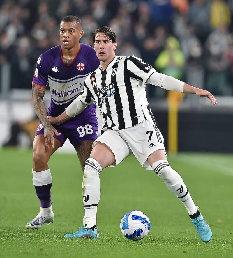 Juventus attacker Dusan Vlahovic under pressure from Fiorentina's Igor. EPA