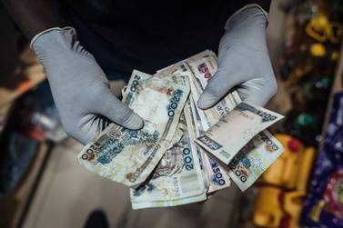 Public officials and health experts say the risk of transferring the virus from person to person through the use of money is minimal, but that hasn't stopped some businesses from refusing to accept banknotes. Photo: Bloomberg