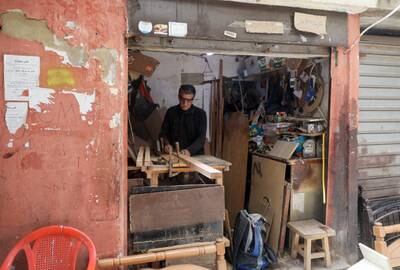 A carpenter works in his workshop in the Palestinian refugee camp of Shatila. AFP