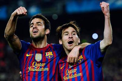 FC Barcelona's Lionel Messi, from Argentina, right, reacts after scoring against AC Milan with his teammate Cesc Fabregas during the 2nd leg, quarterfinal Champions League soccer match at the Camp Nou, in Barcelona, Spain, Tuesday, April 3, 2012. (AP Photo/Manu Fernandez)