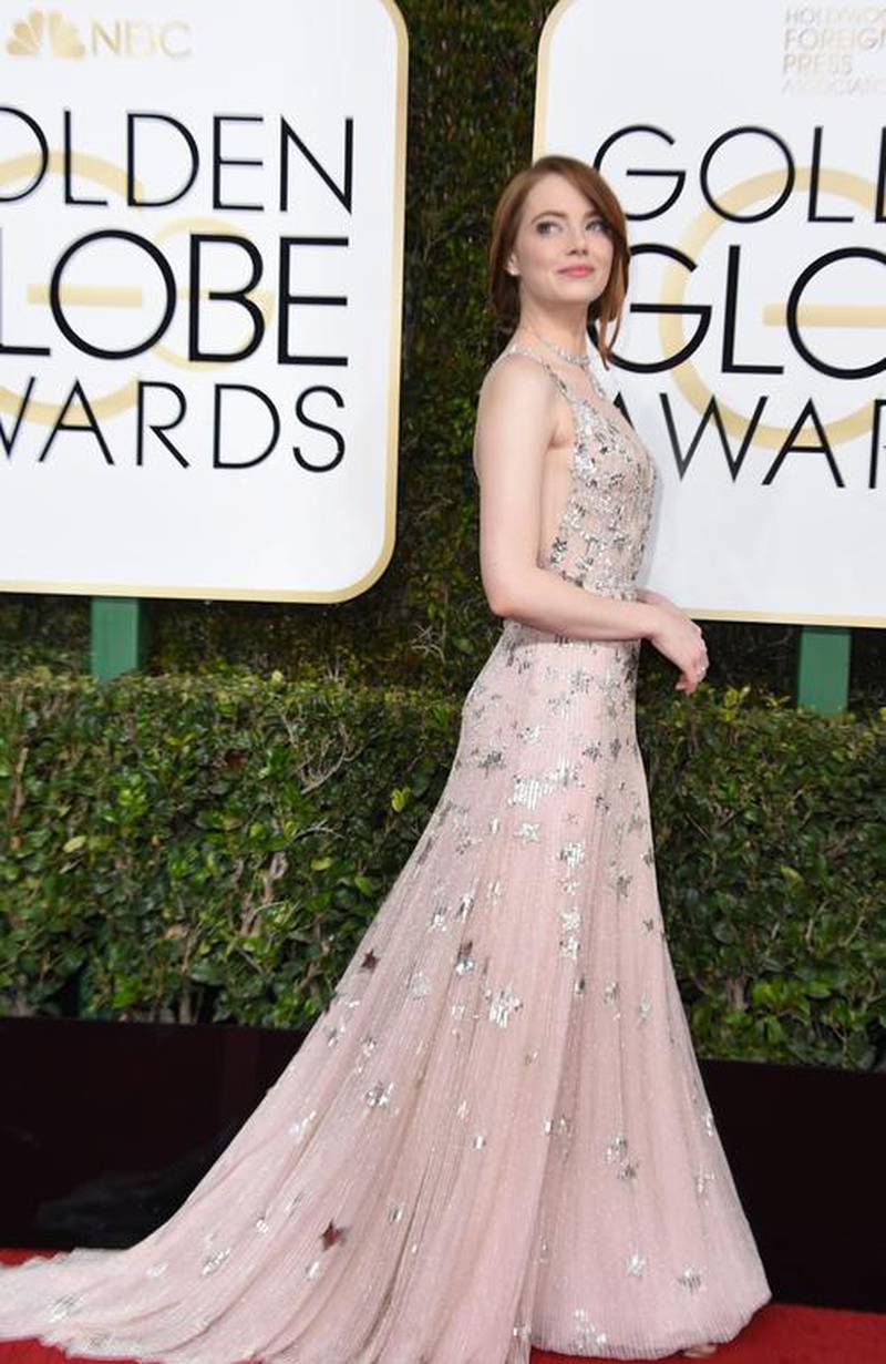 Emma Stone expertly paired a Valentino gown with Jimmy Choo shoes and Tiffany jewels. Valerie Macon / AFP