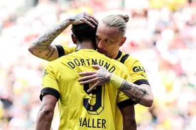 Dortmund's Sebastien Haller celebrates with teammate Marius Wolf after scoring the opening goal against Augsburg. EPA