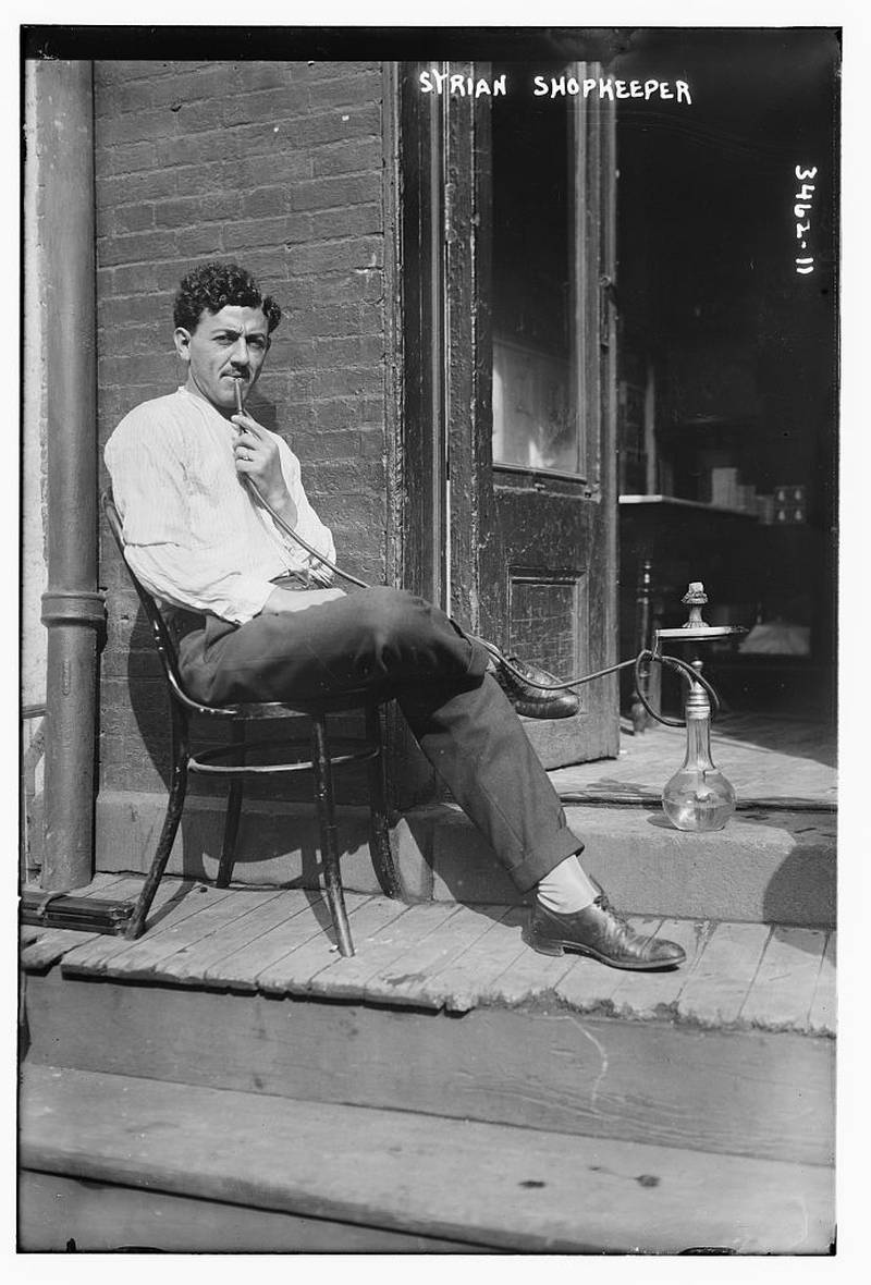 A man smokes a pipe on his porch in Little Syria more than a century ago. Photo: Library of Congress