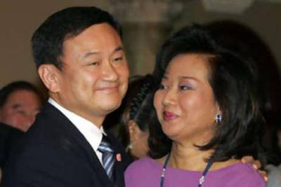 The former Thai prime minister Thaksin Shinawatra hugging his wife Pojaman. Nearly two years after he was deposed by a military coup, Mr Thaksin went on trial for corruption.