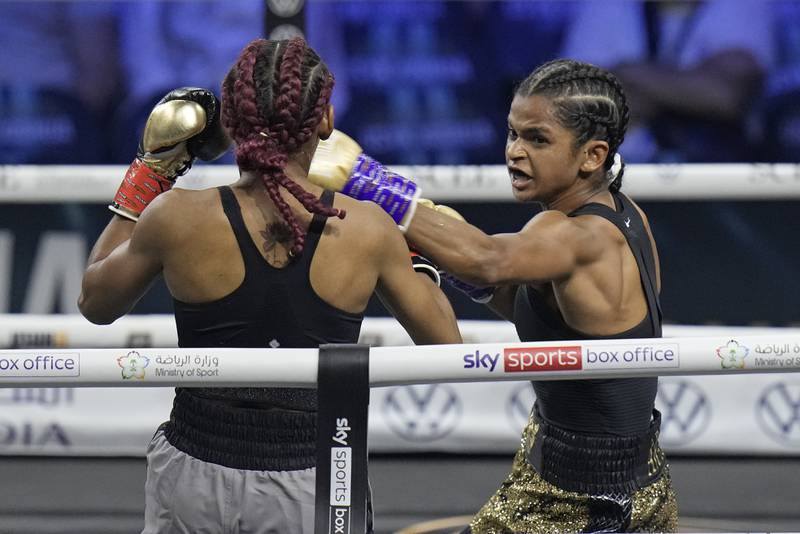 Ramla Ali, right, stops Crystal Garcia Nova of the Dominican Republic to win their super-bantamweight boxing fight at King Abdullah Sports City in Jeddah, Saudi Arabia, on August  20, 2022.  AP