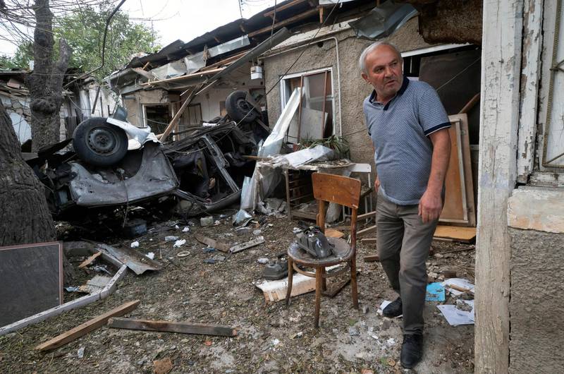 A man walks in the yard of a house destroyed by shelling by Azerbaijan's artillery in Stepanakert, the main city in the separatist region of Nagorno-Karabakh. AP