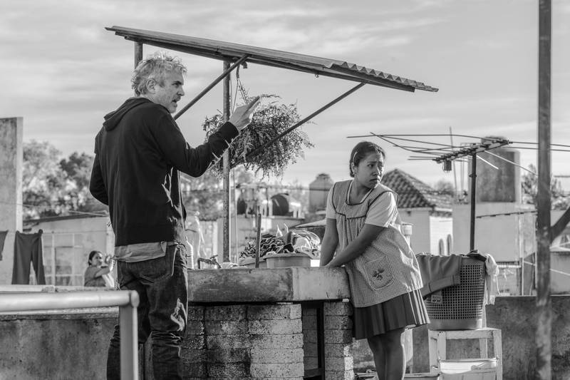 This image released by Netflix shows filmmaker Alfonso Cuaron, left, and actress Yalitza Aparicio on the set of "Roma." On Thursday, Dec. 6, 2018, Cuaron was nominated for a Golden Globe award for best director for the film. The 76th Golden Globe Awards will be held on Sunday, Jan. 6. (Carlos Somonte/Netflix via AP)