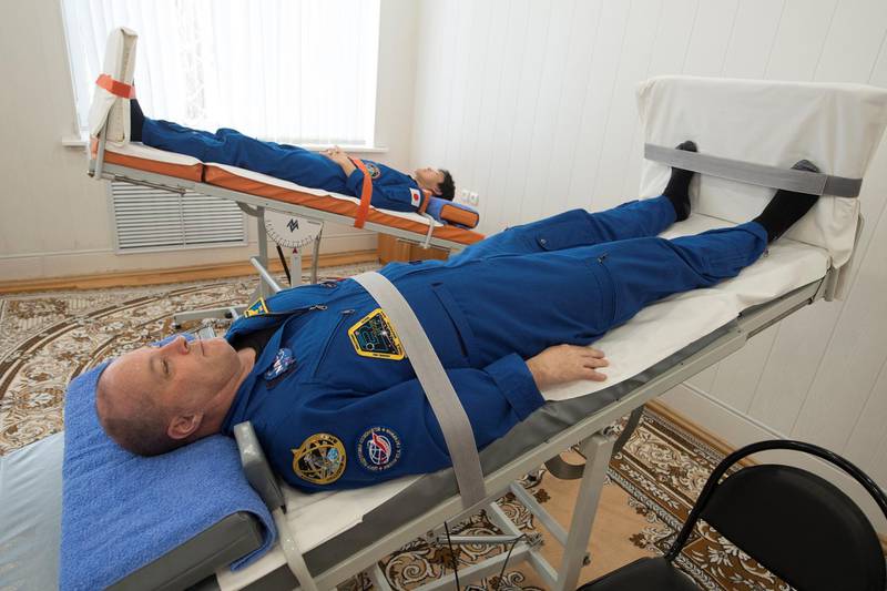 Members of the International Space Station (ISS) expedition 54/55, NASA astronaut Scott Tingle and Norishige Kanai (background) of the Japan Aerospace Exploration Agency (JAXA) practice at the Russian leased Kazakh Baikonur cosmodrome on December 11, 2017. - The space crew is to take off to the International Space Station (ISS) aboard the Soyuz MS-07 on December 17. (Photo by STR / AFP)