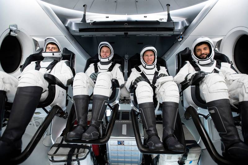 Emirati astronaut Sultan Al Neyadi, right, wears a SpaceX suit as he sits with fellow astronauts in a Dragon Crew Capsule during training for the Crew-6 mission next spring. Photo: Nasa / SpaceX