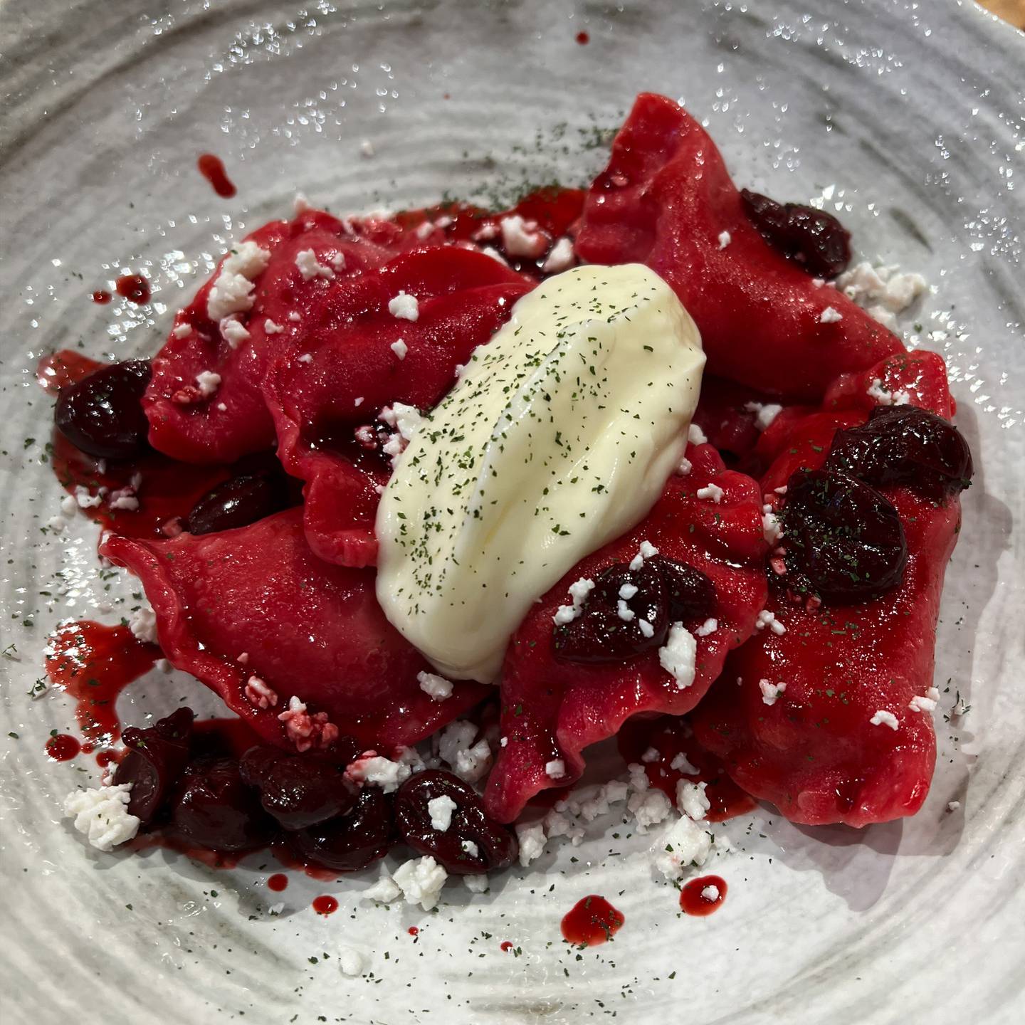 The red varenyky dessert with cherry coulis and sour cream. Photo: Yoy