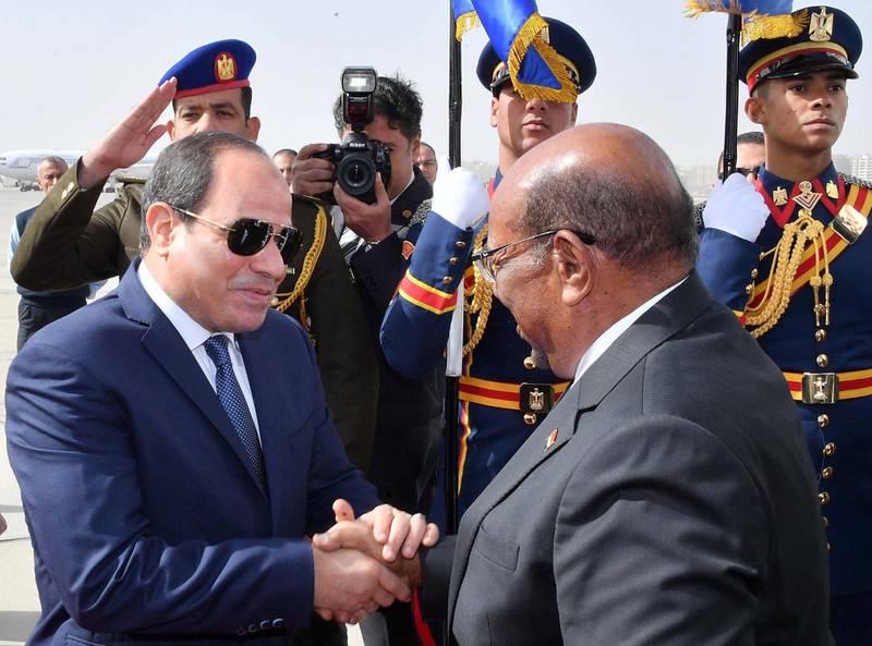 Egyptian President Abdel Fattah al-Sisi shakes hands with Sudan's President Omar al-Bashir at Cairo's Airport, Egypt, January 27, 2019, in this handout picture courtesy of the Egyptian Presidency. The Egyptian Presidency/Handout via REUTERS ATTENTION EDITORS - THIS IMAGE WAS PROVIDED BY A THIRD PARTY