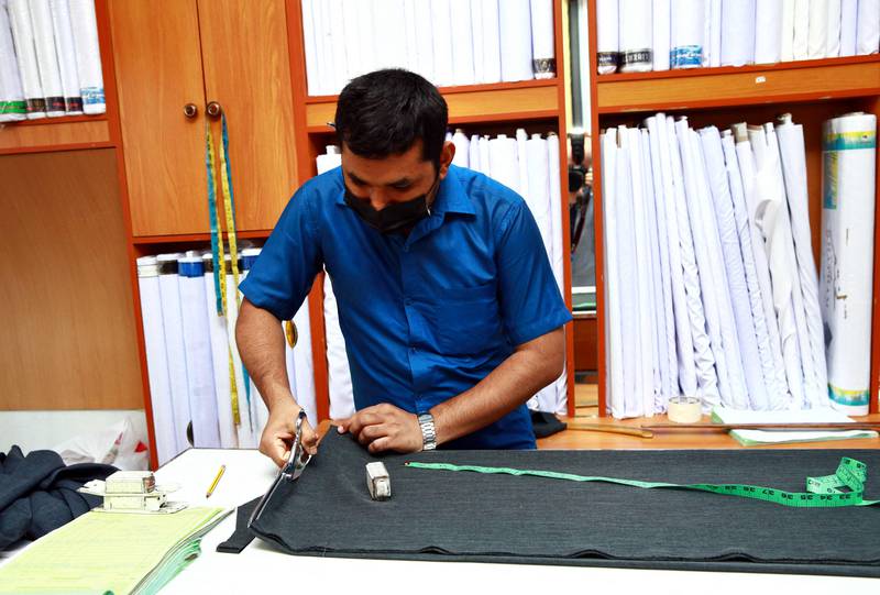 A tailor in Muscat. Manufacturers also face fines for creating clothes that breach the dress code.