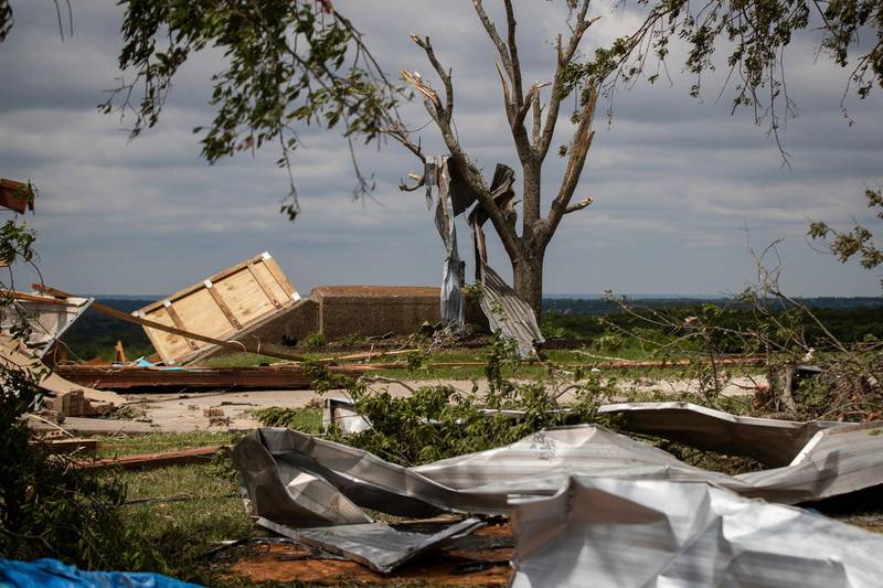 Metal parts of roof are tangled in a tree after a tornado near the storm shelter at the Barn on a wedding venue, May 4, Texas, US. AP