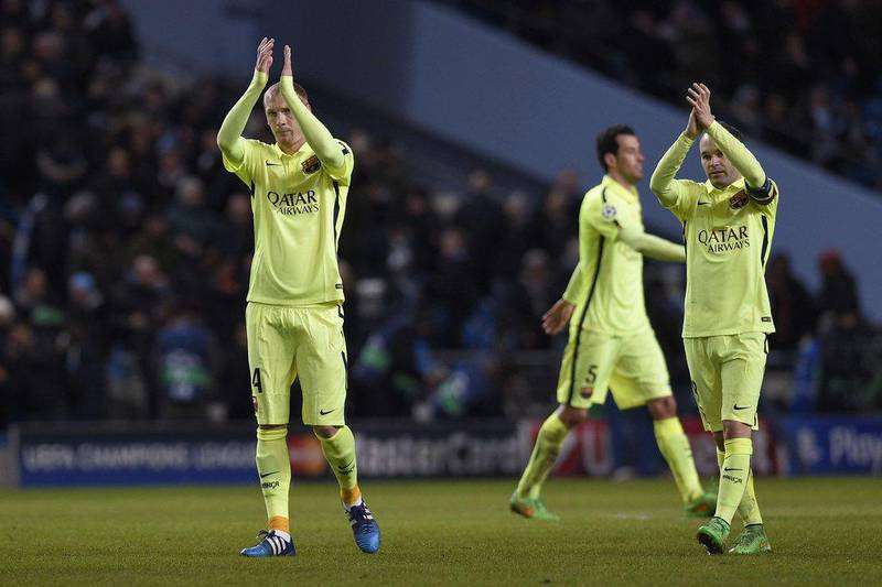 Barcelona's Ivan Rakitic, left, and Andres Iniesta, right, applaud the visiting fans after their 2-1 win over Manchester City at the Etihad Stadium on Tuesday in the Champions League last 16 first leg match. Lluis Gene / AFP