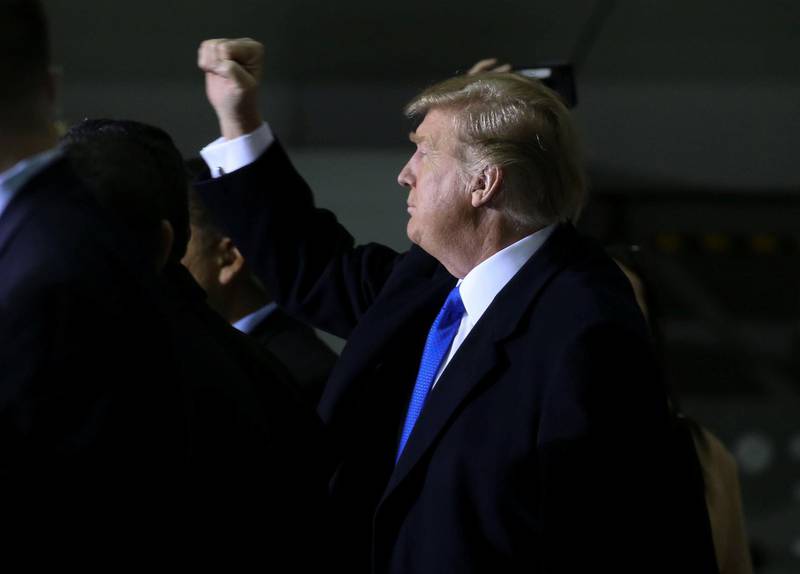 U.S. President Donald Trump thrusts his fist towards members of the U.S. military after addressing them during a refueling stop at Elmendorf Air Force Base in Anchorage, Alaska, U.S., February 28, 2019. REUTERS/Leah Millis