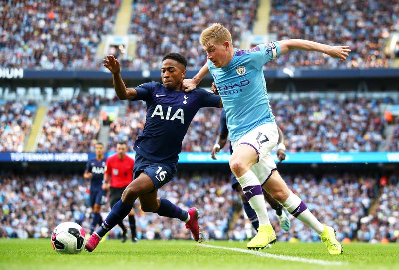MANCHESTER, ENGLAND - AUGUST 17: Kevin De Bruyne of Manchester City challenges for the ball with Kyle Walker-Peters of Tottenham Hotspur during the Premier League match between Manchester City and Tottenham Hotspur at Etihad Stadium on August 17, 2019 in Manchester, United Kingdom. (Photo by Clive Brunskill/Getty Images)