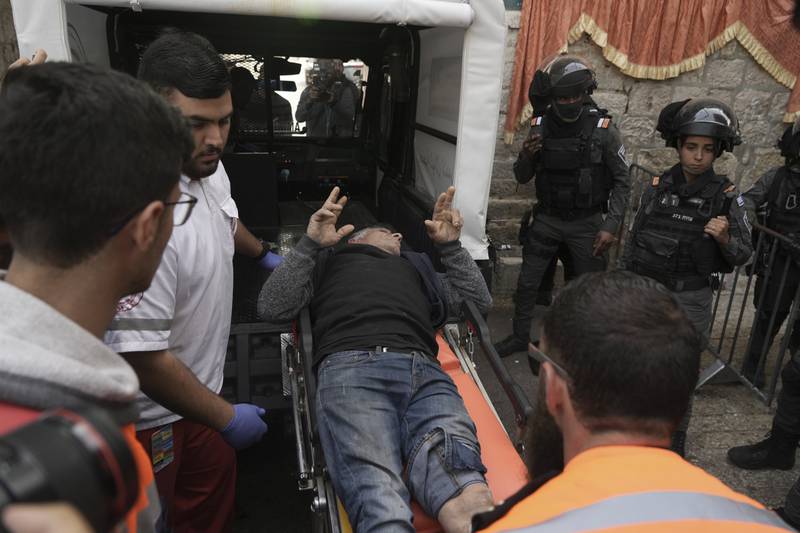 Paramedics carry an injured Palestinian. AP