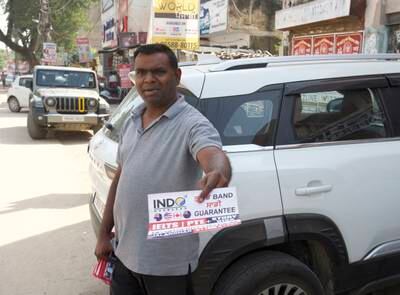 A man distributing flyers for a consultancy centre in Jalandhar in Punjab, India   
