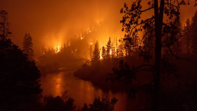 Flames burn down to the banks of the Klamath River during the McKinney Fire. AFP