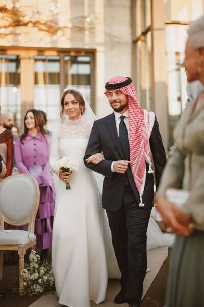 Crown Prince Hussein walks his sister Princess Iman down the aisle. Getty