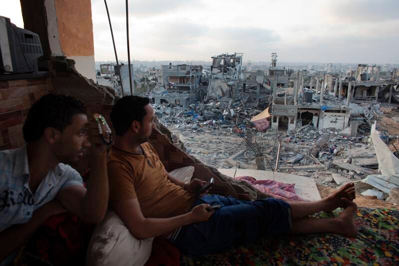 Palestinians in a bedroom of a destroyed home overlooking the destruction  in in the Shejaia neighborhood of Gaza City , Gaza August 15,2014 . Negotiators in Cairo are trying to end the month long war between Hamas and Israel. (Photo by Heidi Levine/Sipa Press).