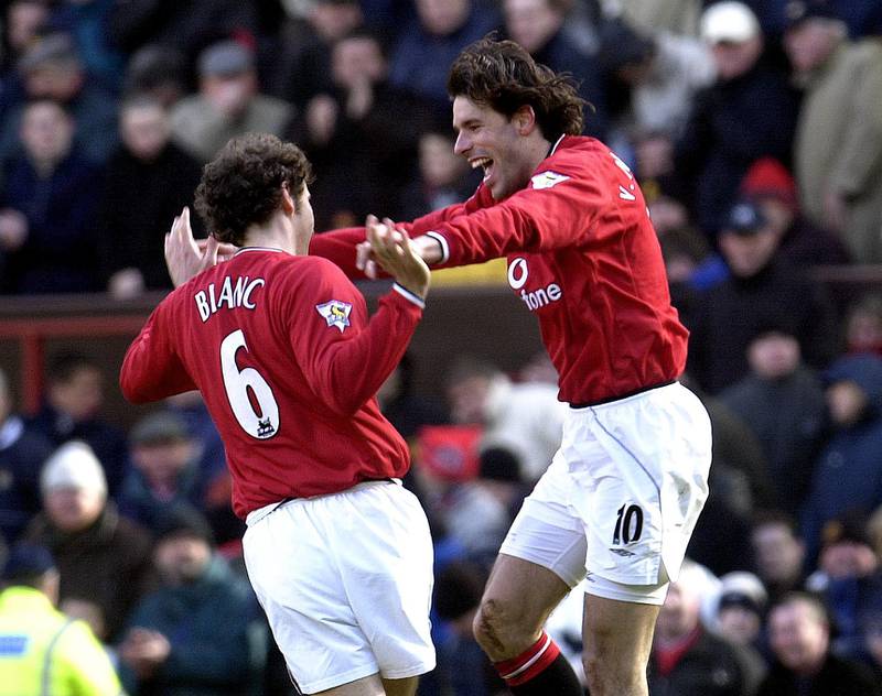 Manchester United teammates Laurent Blanc (L) and Ruud Van Nistelrooy celebrate a goal during the English Barclaycard Premier League match against Aston Villa at Old Trafford, Manchester, 23 February 2002.  AFP PHOTO/PAUL BARKER (Photo by PAUL BARKER / AFP)