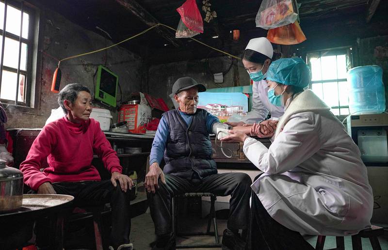 Health workers in Qiandongnan Miao and Dong Autonomous Prefecture, in China's south-western Guizhou province. AFP