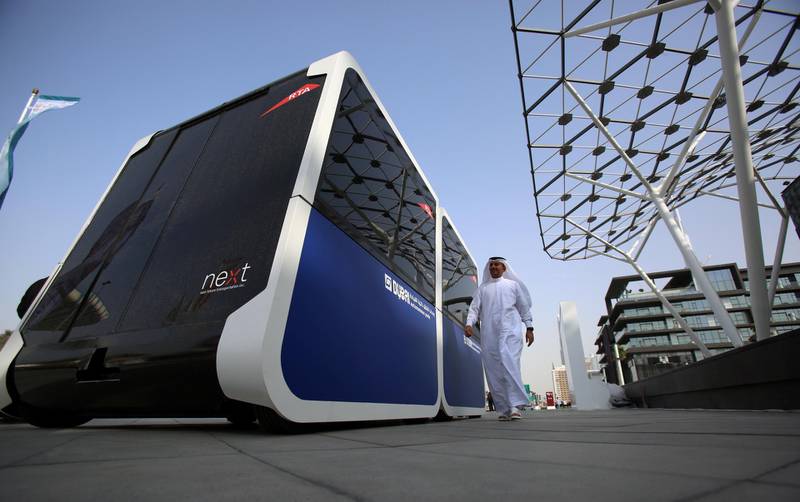 A man walks past the world's first autonomous pods which was launched by the Roads and Transport Authority of Dubai in Dubai, United Arab Emirates February, 28, 2018. Picture taken February, 28, 2018. REUTERS/Satish Kumar - RC1BA7C68C00