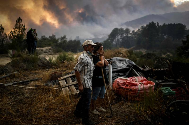 Locals watch as a wildfire advances in Orjais, in central Portugal. AFP