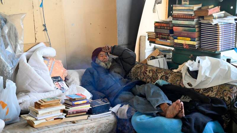 An image that illustrates this article Homeless man who ran bookshop under Beirut bridge loses stock and home in fire