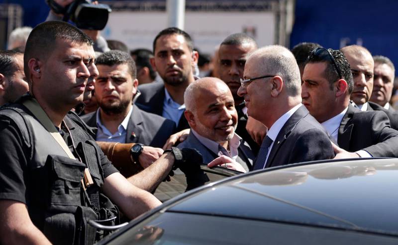Palestinian Prime Minister Rami Hamdallah (second right) is greeted by Hamas' security chief Tawfiq Abu Naim (cente) upon his arrival in Gaza City on March 13, 2018. Mahmud Hams / FP