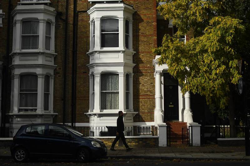 A man walks past houses in Maida Vale in London, England. Getty Images