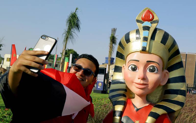 A supporter poses with the official Mascot Tut before the opening match of the 2019 Africa Cup of Nations between Egypt and Zimbabwe at Cairo International Stadium in Cairo, Egypt. EPA