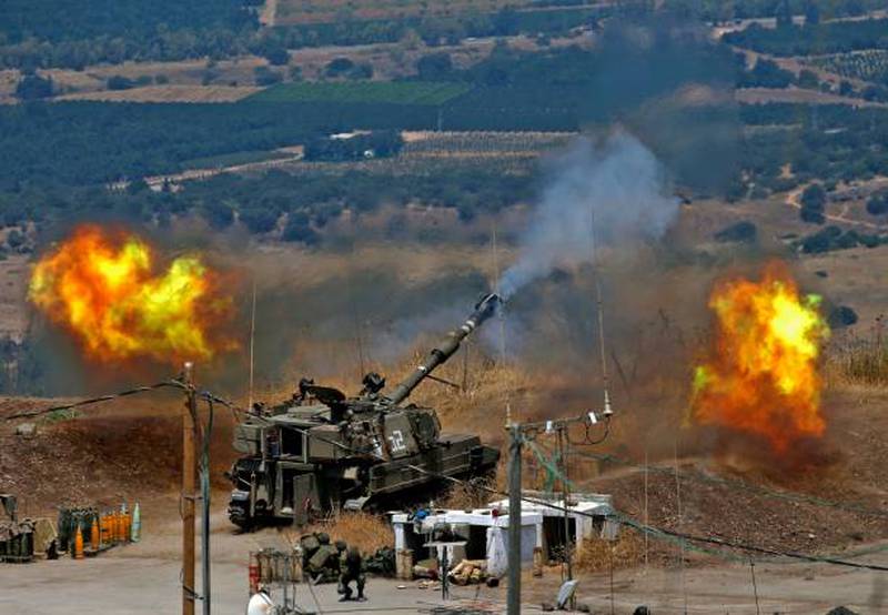 Israeli self-propelled howitzers fire towards Lebanon from a position near the northern Israeli town of Kiryat Shmona following rocket fire from the Lebanese side of the border.