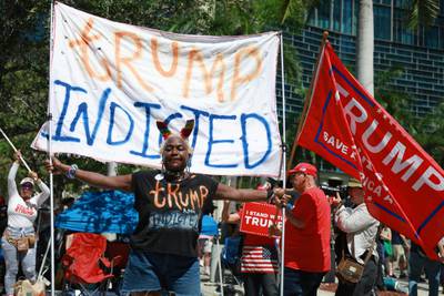 People protest against Mr Trump during his arraignment in Miami. AFP