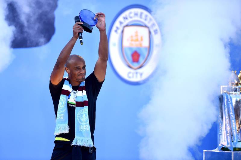 Vincent Kompany of Manchester City lifts his Goal of the Season trophy during the Manchester City Teams Celebration Parade in Manchester, England. Getty Images