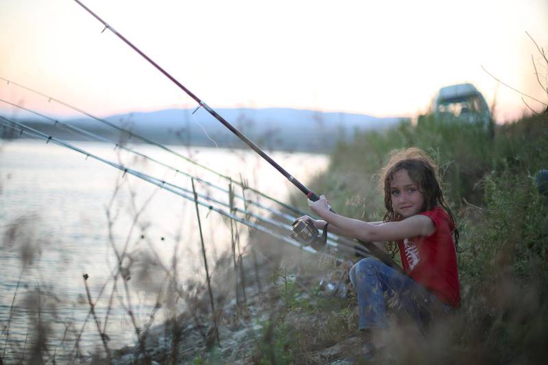 Asala, 8, daughter of a local fisherman, teaches children from besiegedGhouta to fish – many of them had never even seen a lake. Courtesy Tim Alsiofi